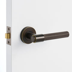 Aged Brass Passage Door Handle Installed on a Door