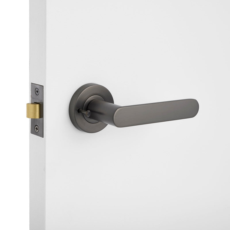 Gunmetal Door handle with lock on a white door