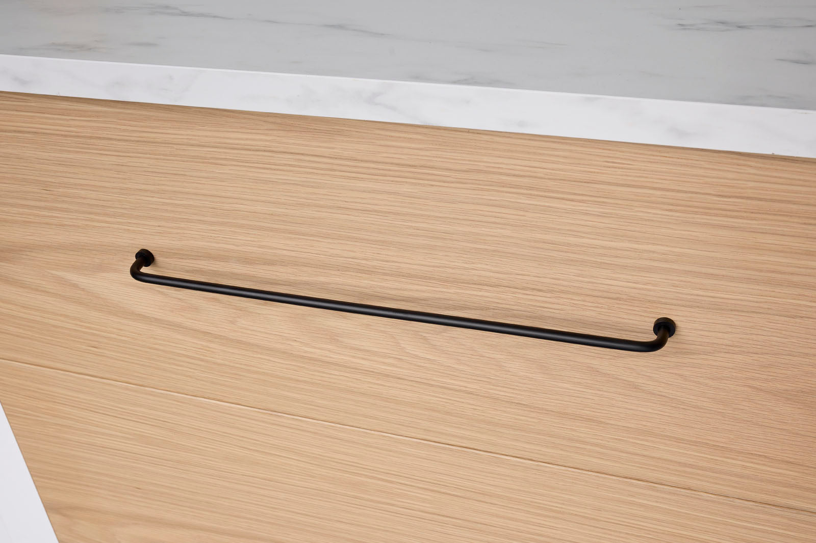 Wooden surface with a black handle on a light wooden background